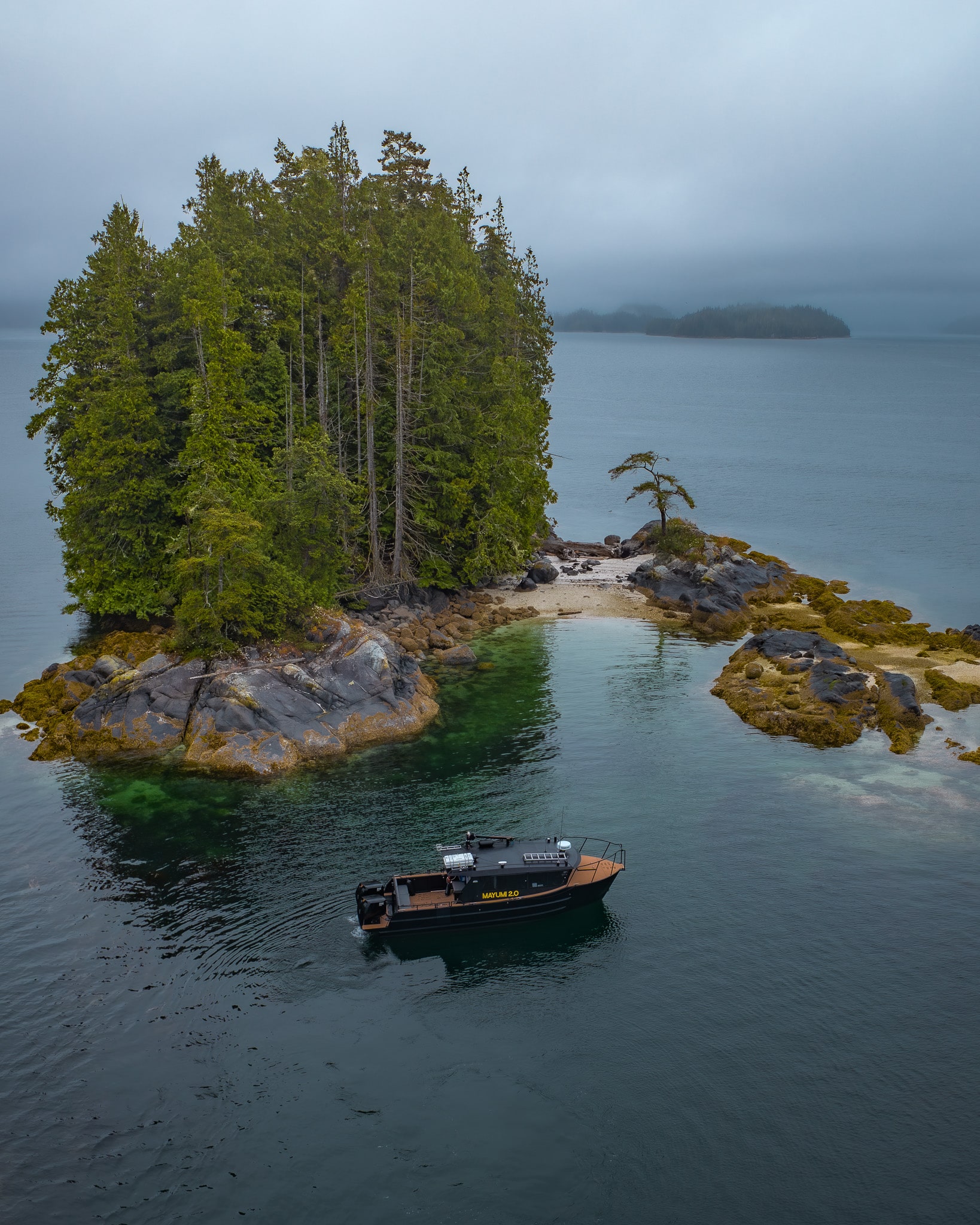 The Mayumi 2.0 anchored in a remote coastal cove
