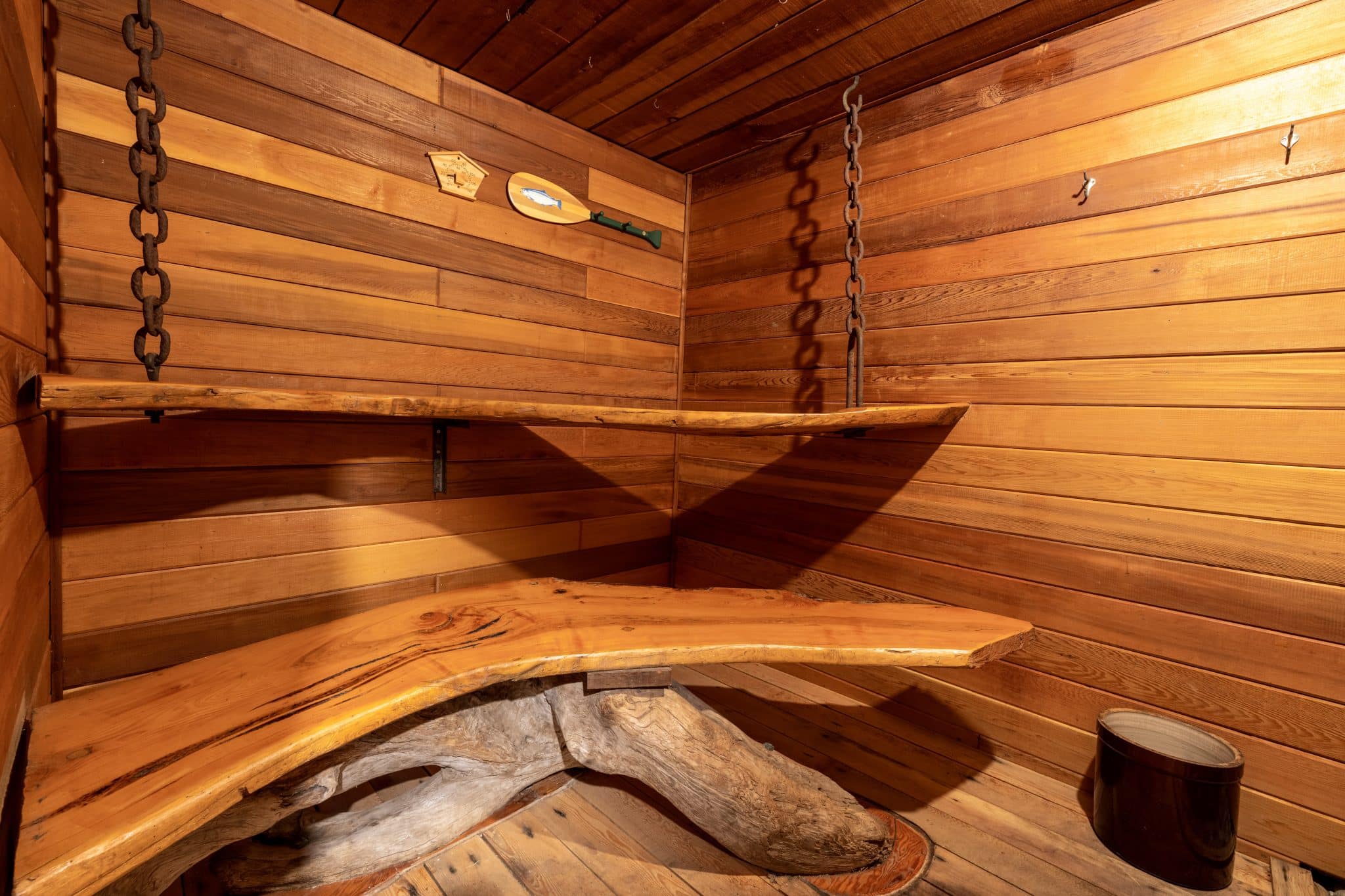Cedar sauna with traditional woodwork and carved salmon, showing Indigenous craftsmanship at Sea Wolf Lodge