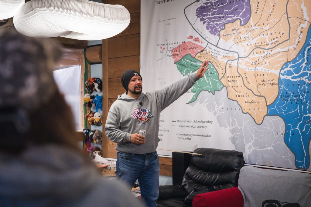 Mike Willie of Sea Wolf Adventures teaching guests on the Kwakwa̱ka̱'wakw territorial map at U'mista